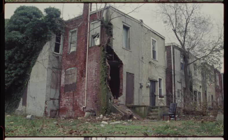 The building is damaged with a side of the wall missing