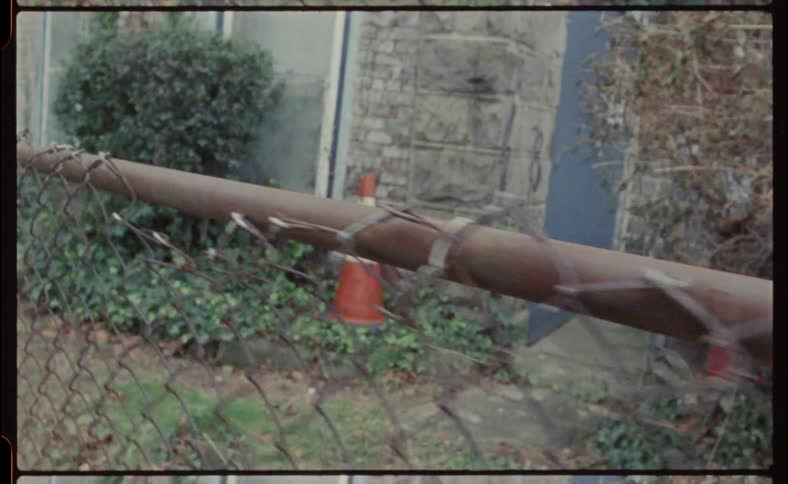Rusty fence by an old building