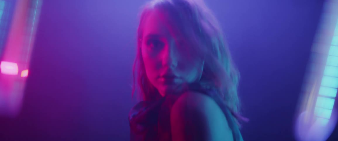 Woman poses under different colored lights