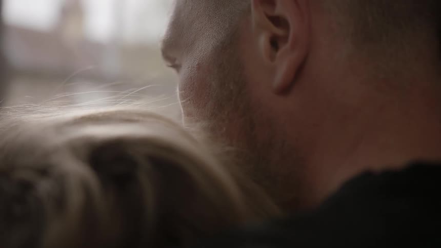 A woman has her head on a man's shoulder