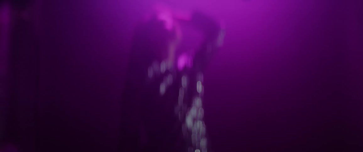 Woman in hazy light plays with hair