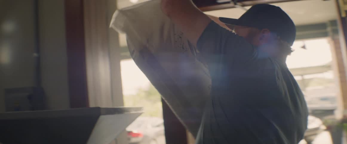 A man pours grain from a bag