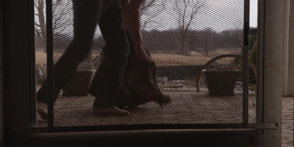 A boy is tying his shoe