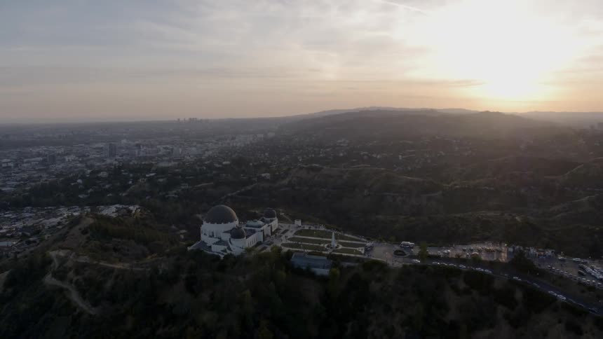 The griffith observatory on a hilltop at sunset