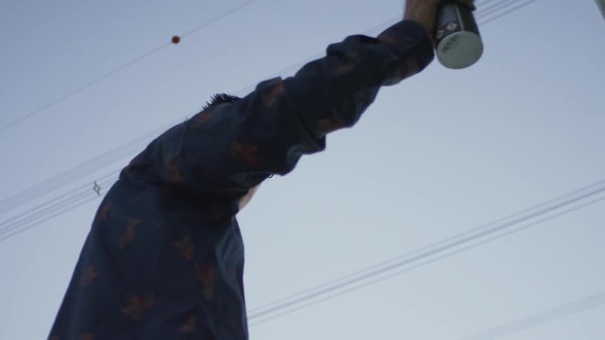A man is spray painting a portrait