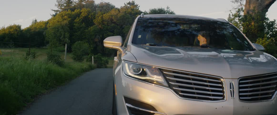 An suv drives down a rural road