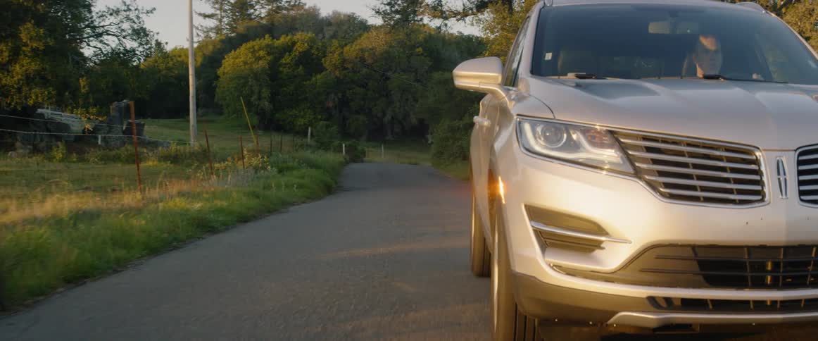 Suv drives down a small country road