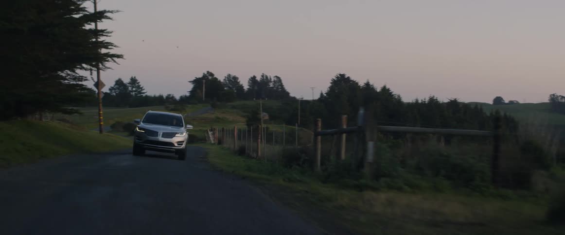 An suv drives down a rural road