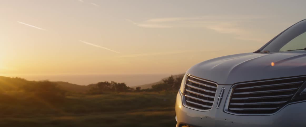 A man drives an suv at sunset