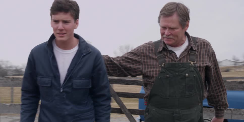 A man is talking to a farmer