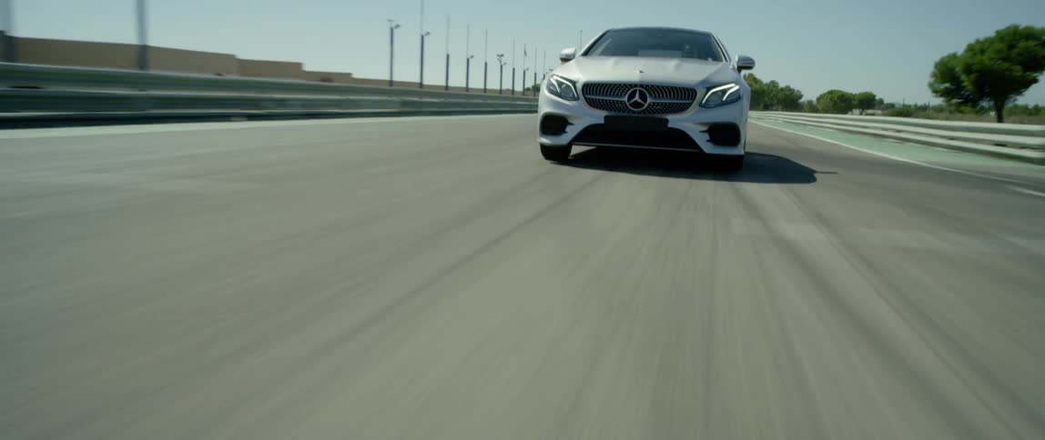 A car drives on a road on a sunny day