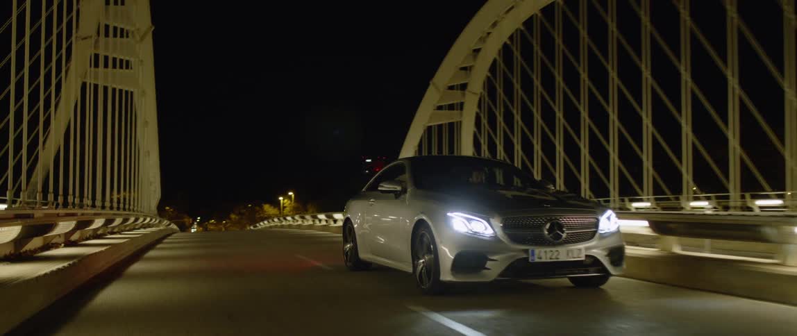 A car drives on a city bridge