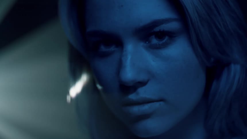 Lights shine behind a woman's head