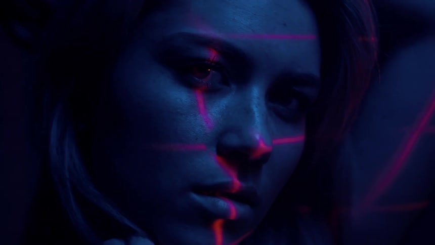 Woman's face illuminated by blue and red light