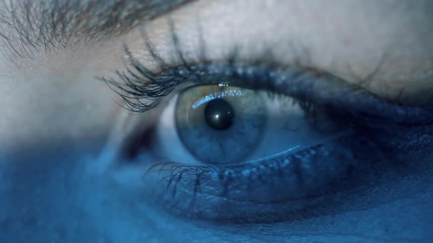 Lights shine on a woman's eye