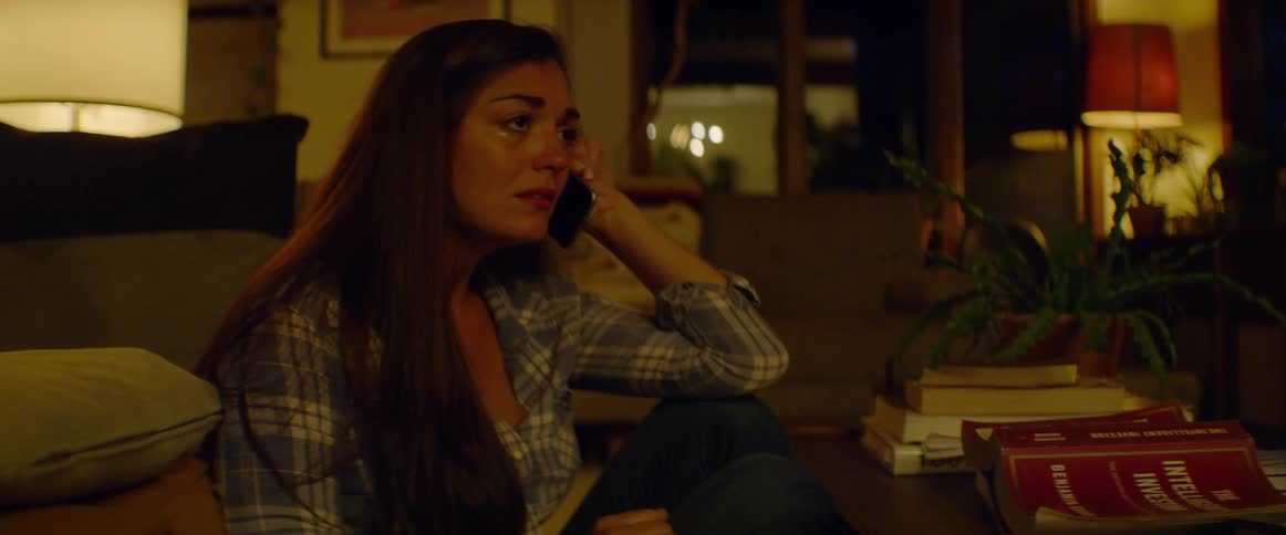A woman cries while talking on the phone