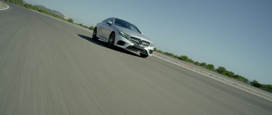 A car drives on a road on a clear day