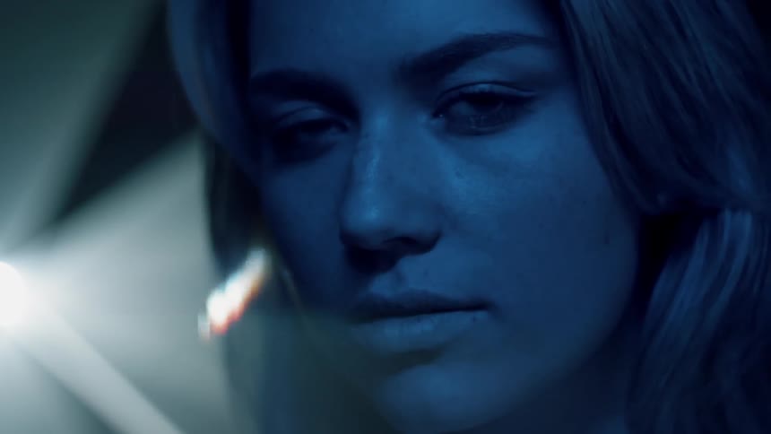 Lights shine behind a woman's head