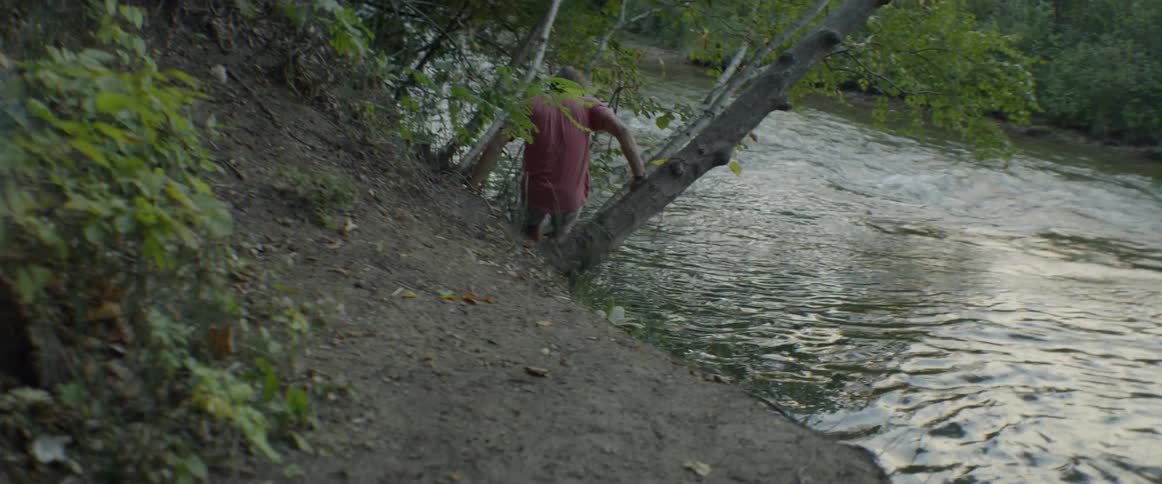 A man climbs into a river