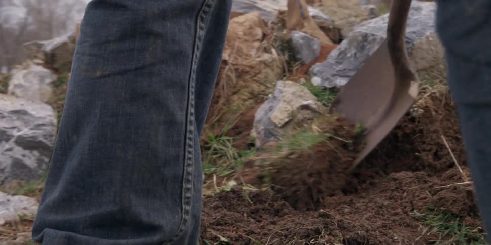 A man is digging up rocks