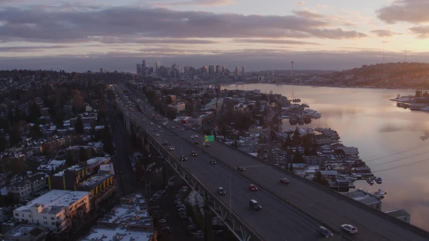 Traffic moving across a double decker bridge through a city neighborhood