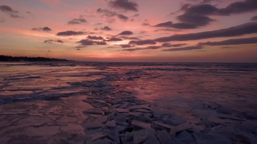 Sun sets over icy watery land