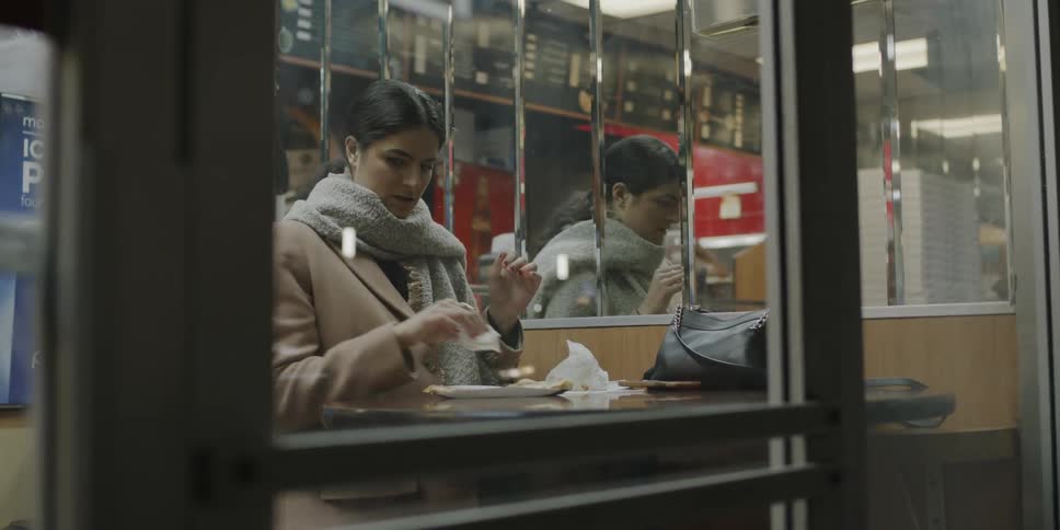 A woman eats in a restaurant