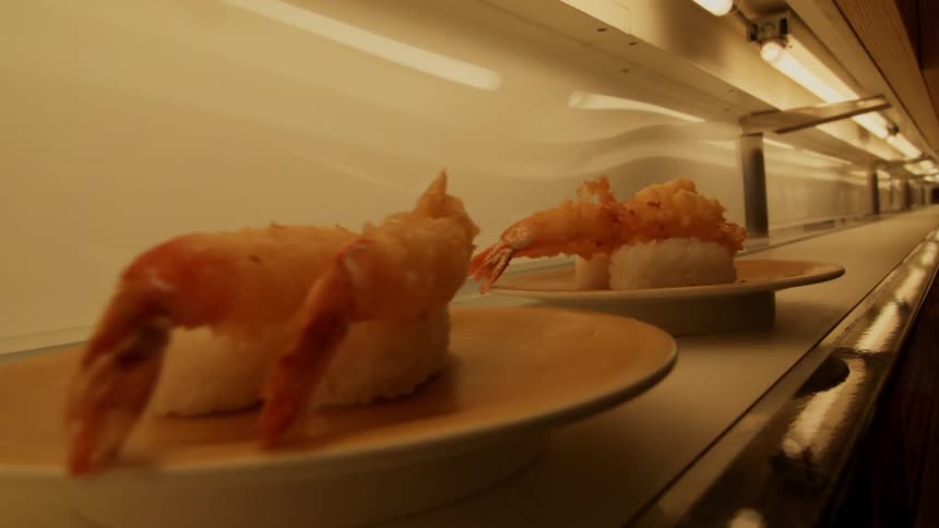 Plates of food come down fast on the conveyor