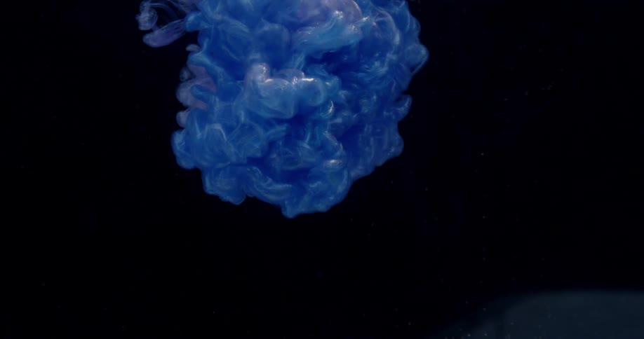 Blue dye swirls and flows underwater