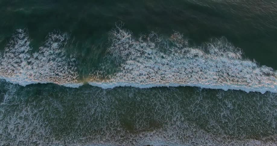 The waves move fast against the shore