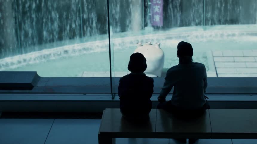 Couple watching waterfall through a window