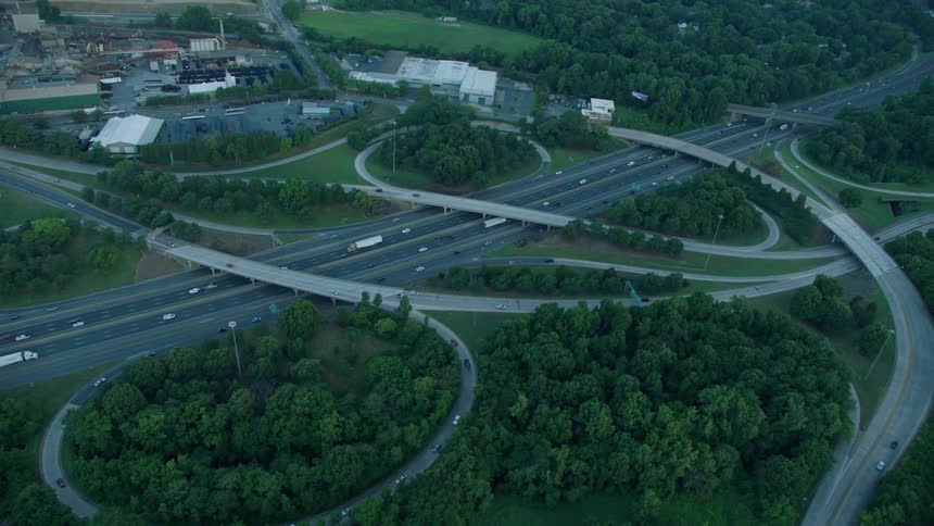 Cars travel under a highway interchange