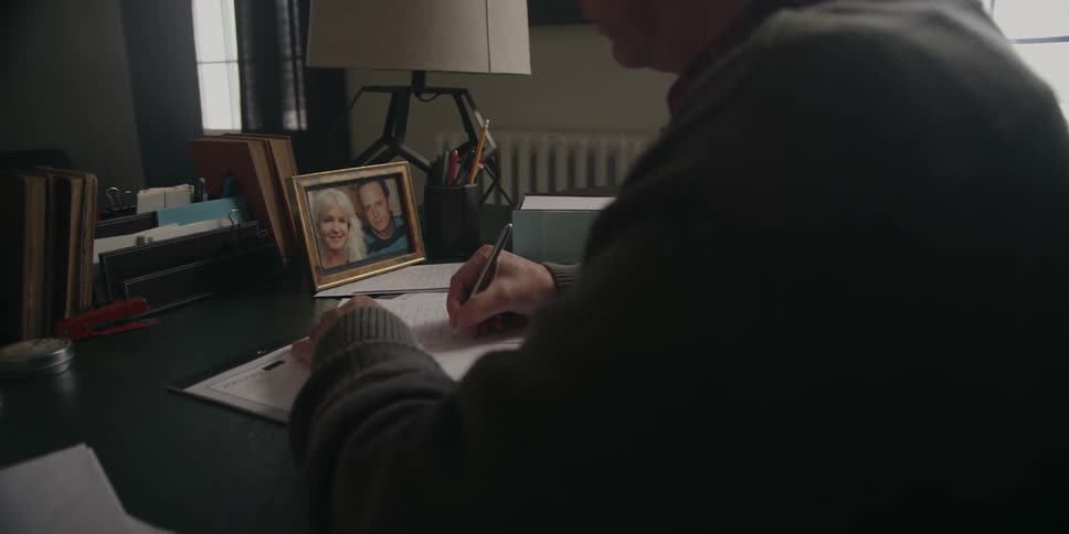 A man is writing a letter