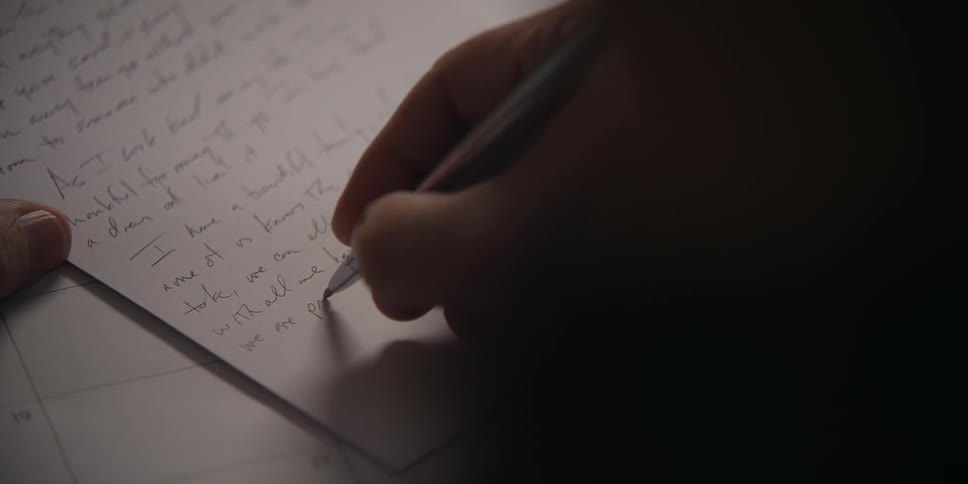 A person is writing a letter