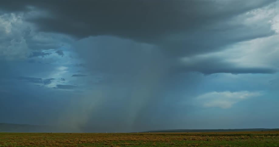 A large rain storm is flaring in the distance