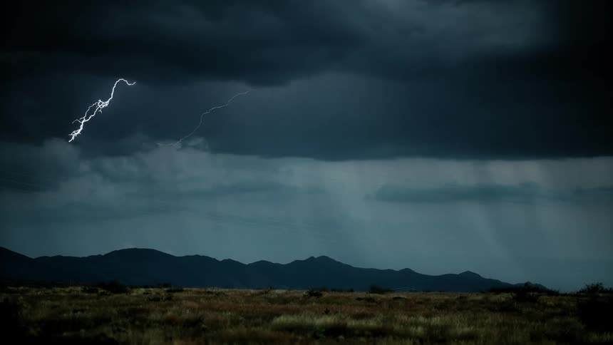 Lightning flashes over a mountain range