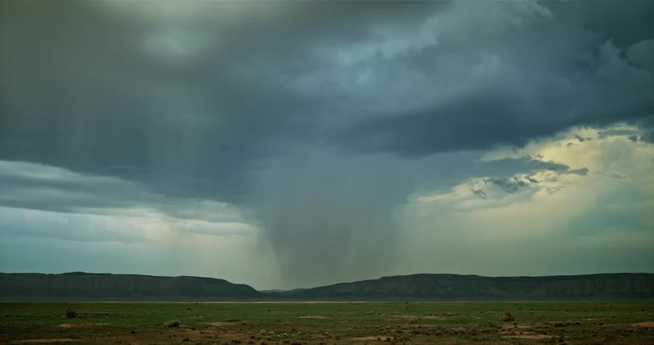 Lightning flashes over mountains during a rainstorm