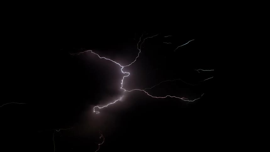 Streaks of lightning illuminate in the dark sky