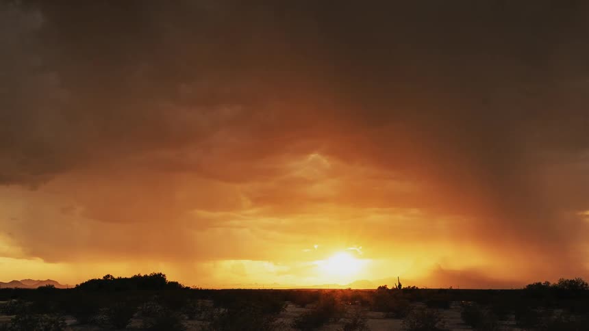 Storm clouds and rain move over a landscape