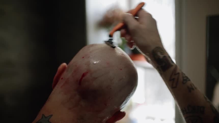 A man shaves his head