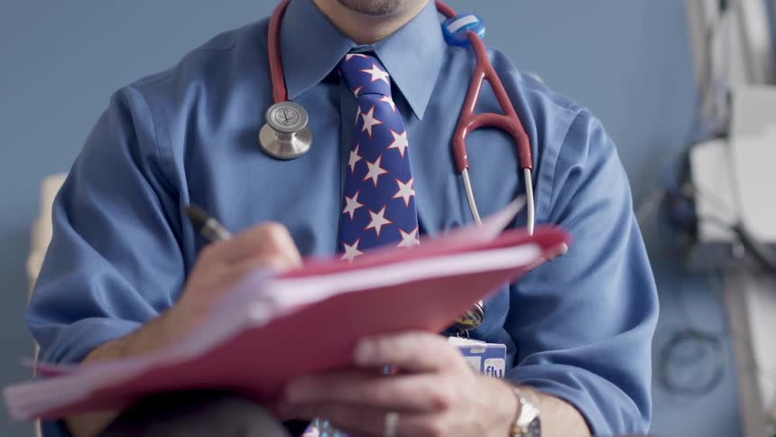 Physician makes notes in chart