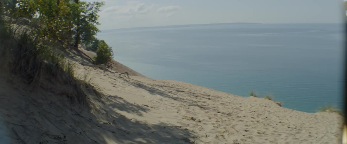 A sandy slope overlooks the ocean