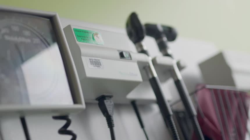 Medical instruments are hanging on the wall in a doctor's office in daylight