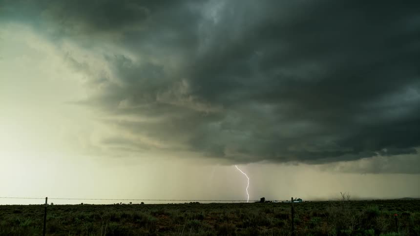Lightning flashes over a rural field