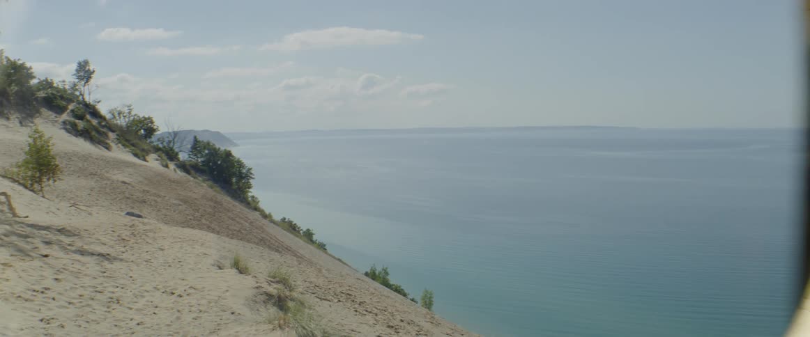 The hill leads off to the water below