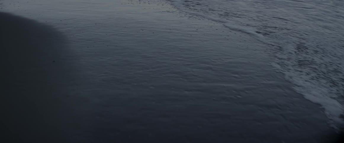 Water splashes to a sandy beach