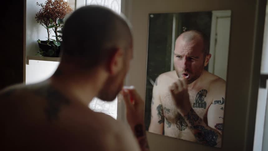 A man brushes his teeth