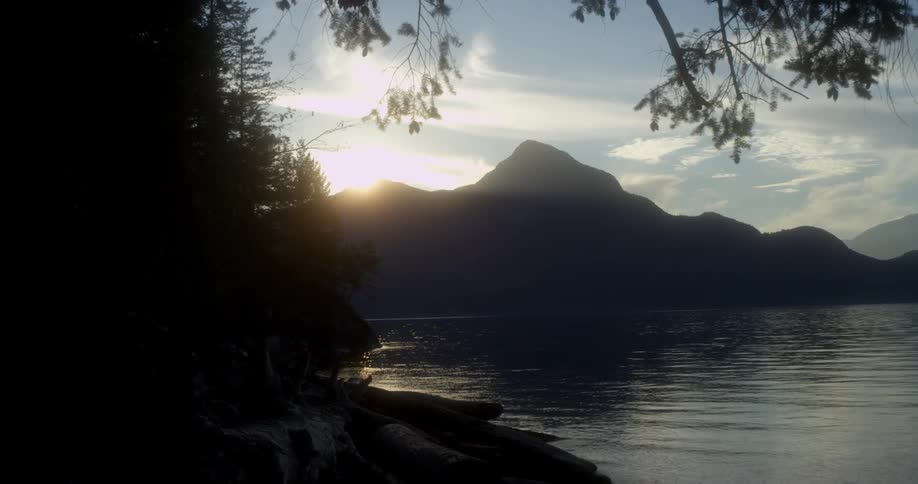 The sun sets over a mountain lake