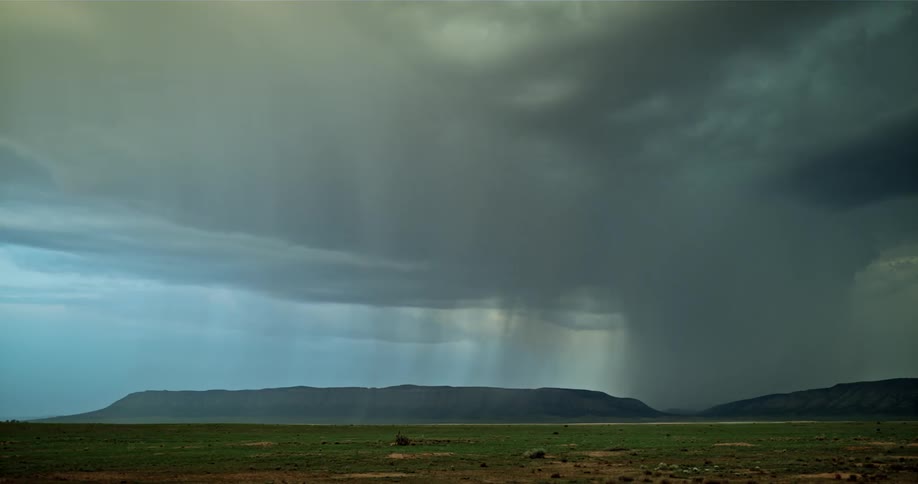 The large storm clouds are shooting lightning on the ground