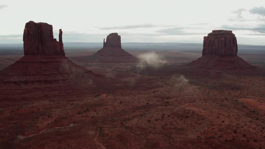 Clouds float near red rock formations